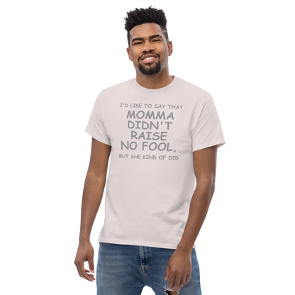 "I'd like to say that momma didn't raise no fool, but she kind of did" printed on a ice grey unisex classic tee worn by a male