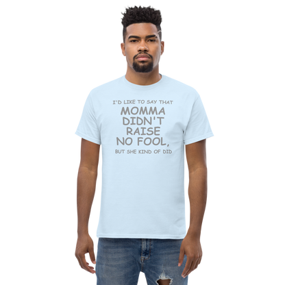 "I'd like to say that momma didn't raise no fool, but she kind of did" printed on a light blue unisex classic tee worn by a male