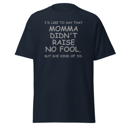 "I'd like to say that momma didn't raise no fool, but she kind of did" printed on a navy unisex classic tee laying on a flat surface