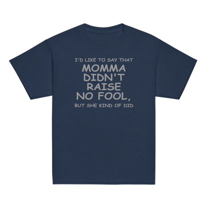 "I'd like to say that momma didn't raise no fool, but she kind of did" printed on a navy youth classic tee laying on a flat surface