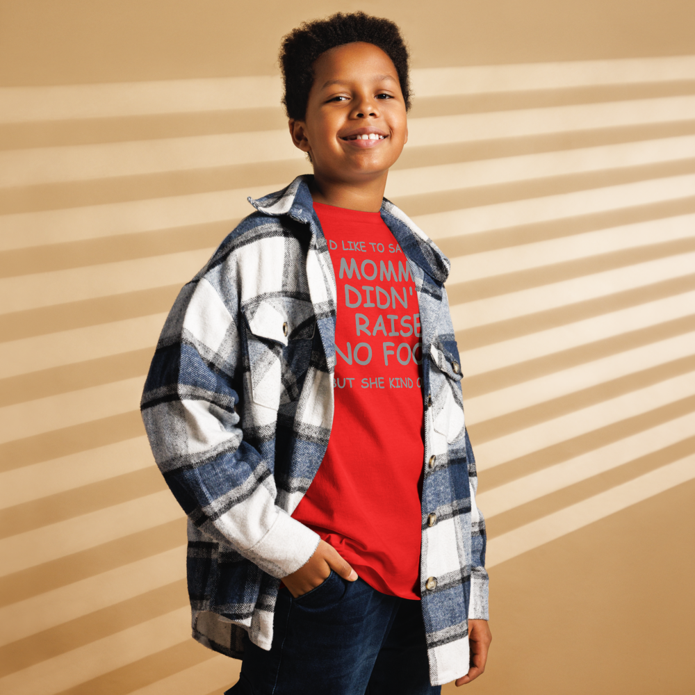 "I'd like to say that momma didn't raise no fool, but she kind of did" printed on a red youth classic tee worn by a male also wearing a jacket