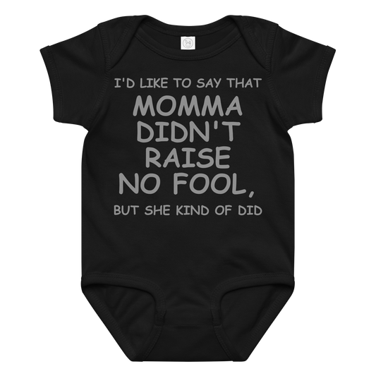 "I'd like to say that momma didn't raise no fool, but she kind of did" printed on a black baby jersey bodysuit laying on a flat surface amongst other clothes