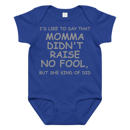 "I'd like to say that momma didn't raise no fool, but she kind of did" printed on a royal baby jersey bodysuit laying on a flat surface amongst other clothes