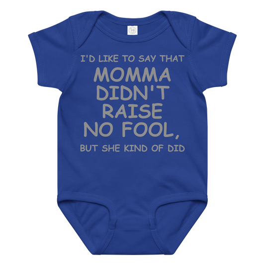 "I'd like to say that momma didn't raise no fool, but she kind of did" printed on a royal baby jersey bodysuit laying on a flat surface amongst other clothes