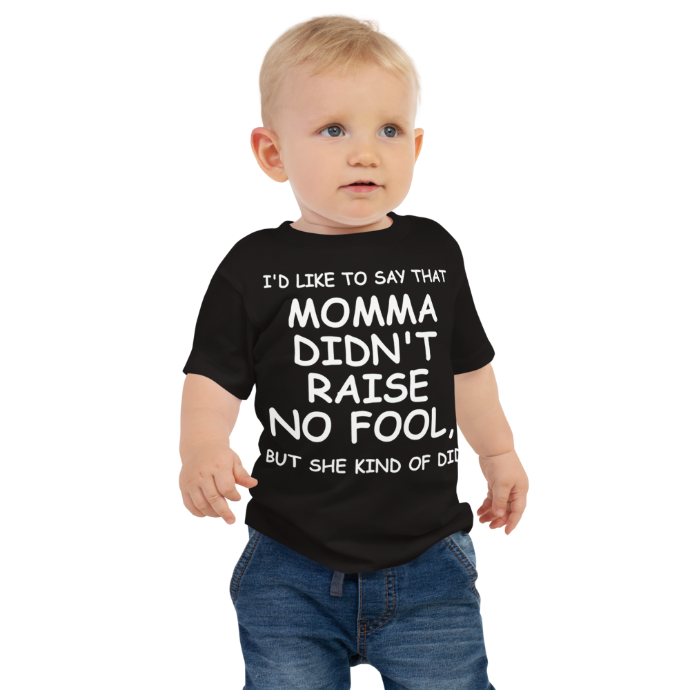 "I'd like to say that momma didn't raise no fool, but she kind of did" printed on a black baby jersey short sleeve tee worn by a male