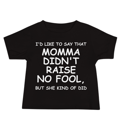 "I'd like to say that momma didn't raise no fool, but she kind of did" printed on a black baby jersey short sleeve tee laying on a flat surface