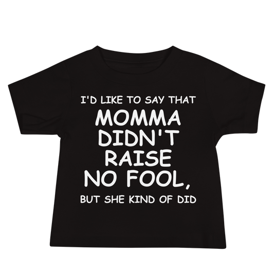 "I'd like to say that momma didn't raise no fool, but she kind of did" printed on a black baby jersey short sleeve tee laying on a flat surface
