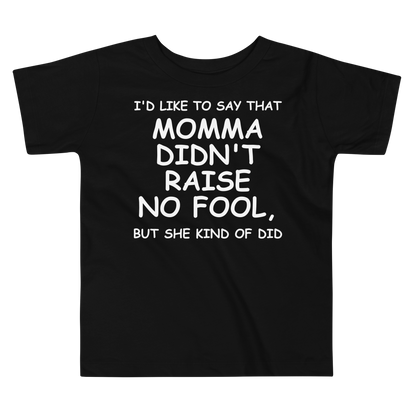 "I'd like to say that momma didn't raise no fool, but she kind of did" printed on a black toddler short sleeve tee laying on a flat surface