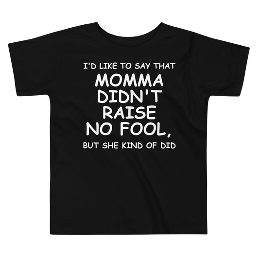 "I'd like to say that momma didn't raise no fool, but she kind of did" printed on a black toddler short sleeve tee laying on a flat surface