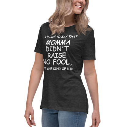 "I'd like to say that momma didn't raise no fool, but she kind of did" printed on a dark grey heather women's relaxed t-shirt worn by a female