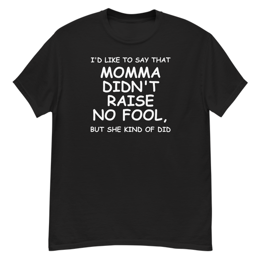 "I'd like to say that momma didn't raise no fool, but she kind of did" printed on a black unisex classic tee laying on a flat surface