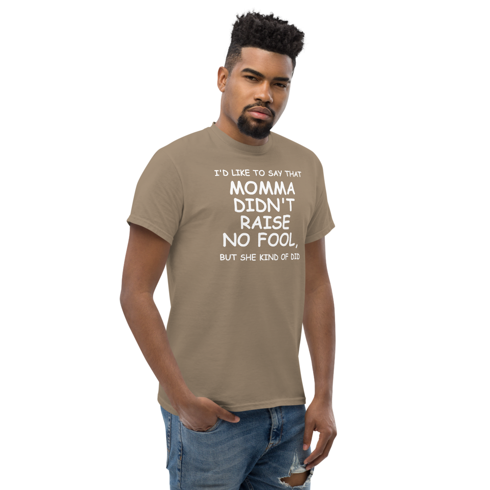 "I'd like to say that momma didn't raise no fool, but she kind of did" printed on a brown savana unisex classic tee worn by a male