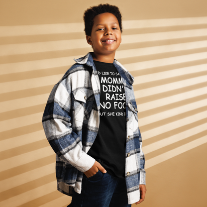 "I'd like to say that momma didn't raise no fool, but she kind of did" printed on a black youth classic tee worn by a male also wearing a jacket
