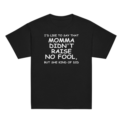 "I'd like to say that momma didn't raise no fool, but she kind of did" printed on a black youth classic tee laying on a flat surface