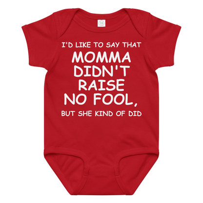 "I'd like to say that momma didn't raise no fool, but she kind of did" printed on a red baby jersey bodysuit laying on a flat surface amongst other clothes