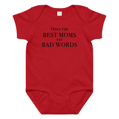 "Only the best moms say bad words" printed on a red baby jersey bodysuit laying on a flat surface amongst other clothes