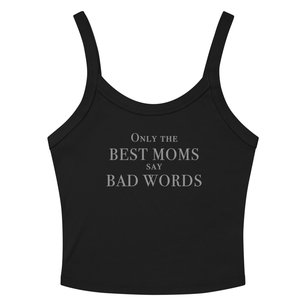 "Only the best moms say bad words" printed on a solid black blend women's micro-rib tanktop laying on a flat surface amongst sunglasses and shorts