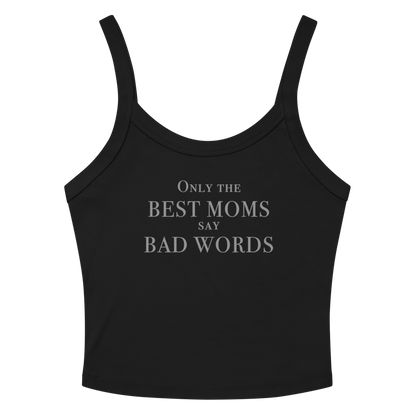 "Only the best moms say bad words" printed on a solid black blend women's micro-rib tanktop laying on a flat surface amongst sunglasses and shorts