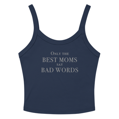 "Only the best moms say bad words" printed on a solid navy blend women's micro-rib tanktop laying on a flat surface amongst sunglasses and shorts