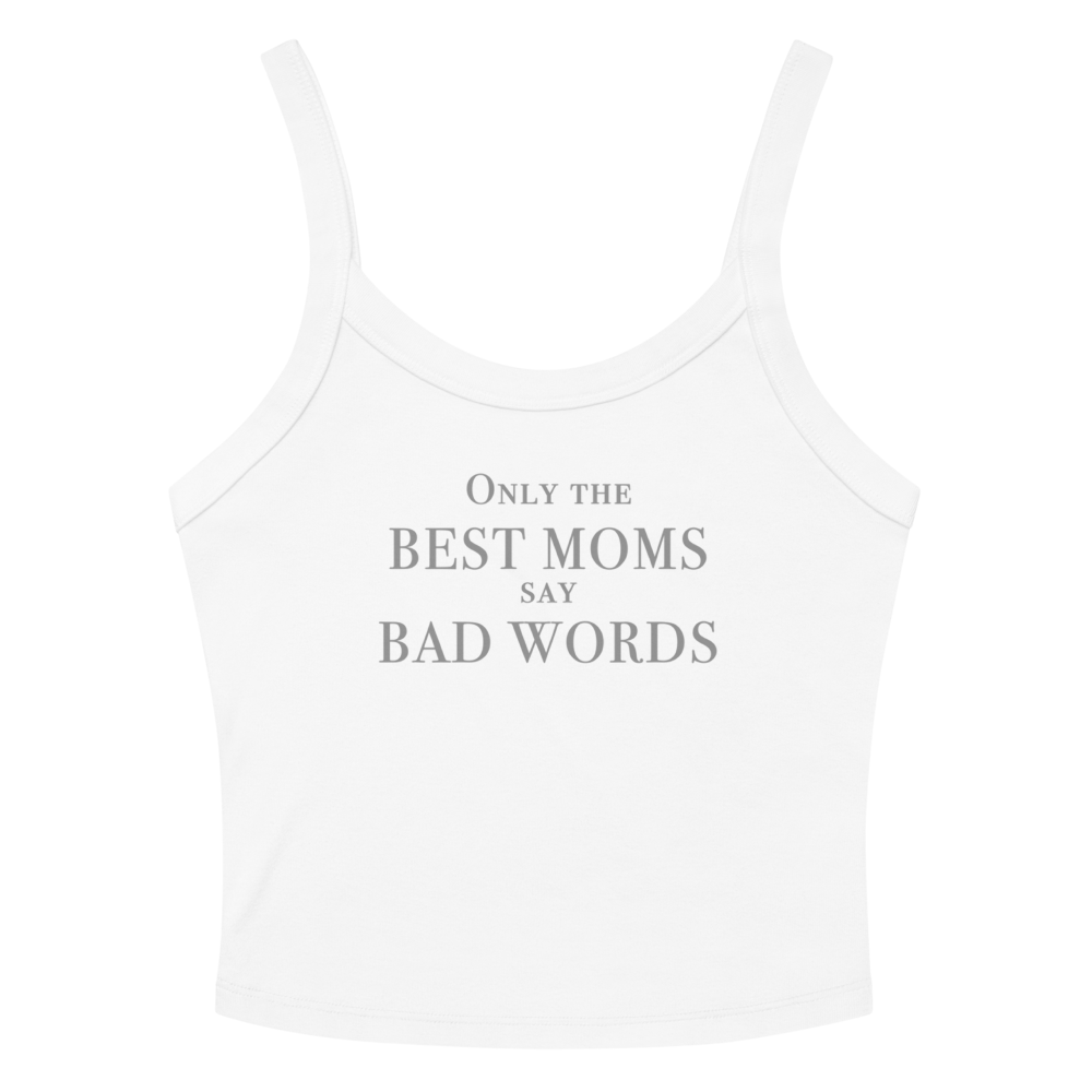 "Only the best moms say bad words" printed on a solid white blend women's micro-rib tanktop laying on a flat surface amongst sunglasses and shorts