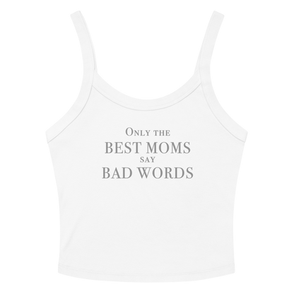 "Only the best moms say bad words" printed on a solid white blend women's micro-rib tanktop laying on a flat surface amongst sunglasses and shorts