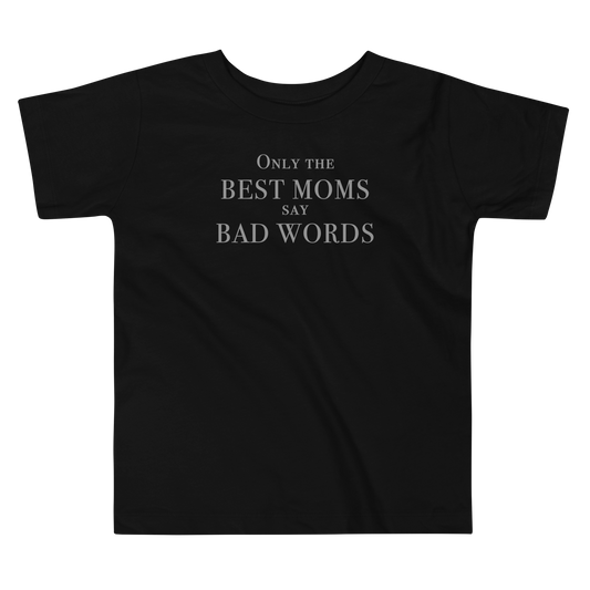 "Only the best moms say bad words" printed on a black toddler short sleeve tee laying on a flat surface