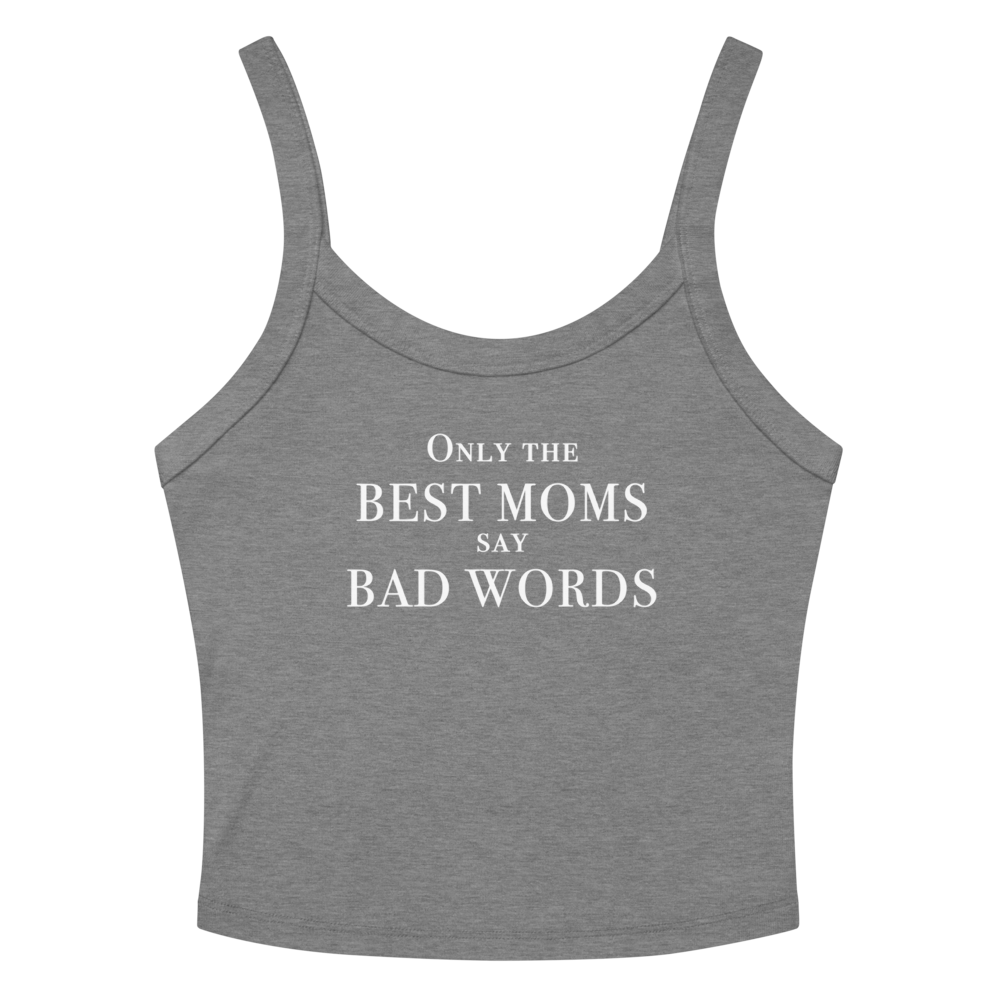 "Only the best moms say bad words" printed on a athletic heather women's micro-rib tanktop laying on a flat surface amongst sunglasses and shorts