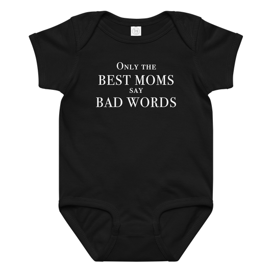 "Only the best moms say bad words" printed on a black baby jersey bodysuit laying on a flat surface amongst other clothes