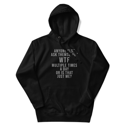 "Anyone else ask themselves WTF multiple times a day or is that just me?" printed on a black unisex hoodie laying on a flat surface with the hood up