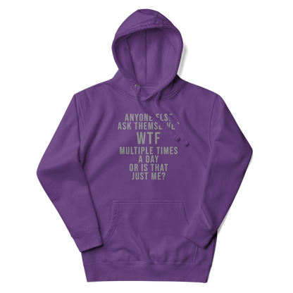 "Anyone else ask themselves WTF multiple times a day or is that just me?" printed on a purple unisex hoodie laying on a flat surface with the hood up