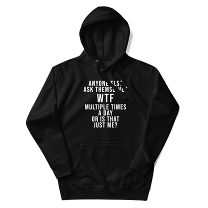 "Anyone else ask themselves WTF multiple times a day or is that just me?" printed on a black unisex hoodie laying on a flat surface with the hood up