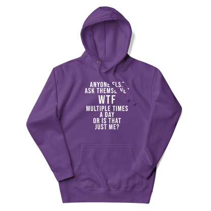 "Anyone else ask themselves WTF multiple times a day or is that just me?" printed on a purple unisex hoodie laying on a flat surface with the hood up