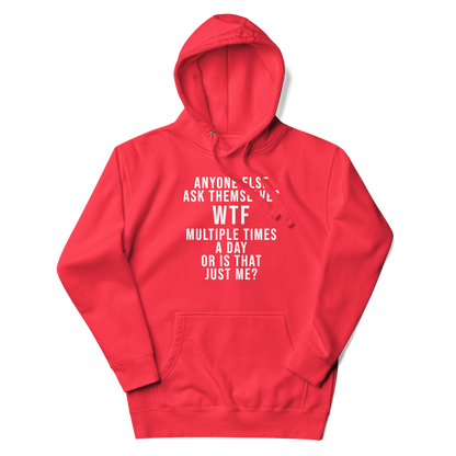"Anyone else ask themselves WTF multiple times a day or is that just me?" printed on a team red unisex hoodie laying on a flat surface with the hood up