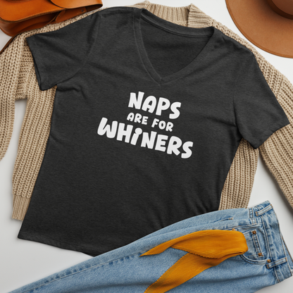 "Naps Are For Whiners" printed on a dark grey heather women's relaxed v-neck t-shirt laying on a flat surface amongst other clothes