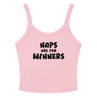 "Naps Are For Winners" printed on a solid pink blend women's micro-rib tanktop laying on a flat surface amongst sunglasses and shorts