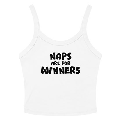 "Naps Are For Winners" printed on a solid white blend women's micro-rib tanktop laying on a flat surface amongst sunglasses and shorts