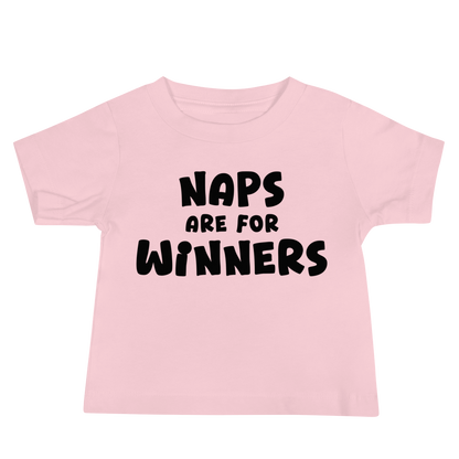 "Naps Are For Winners" printed on a pink baby jersey short sleeve tee laying on a flat surface