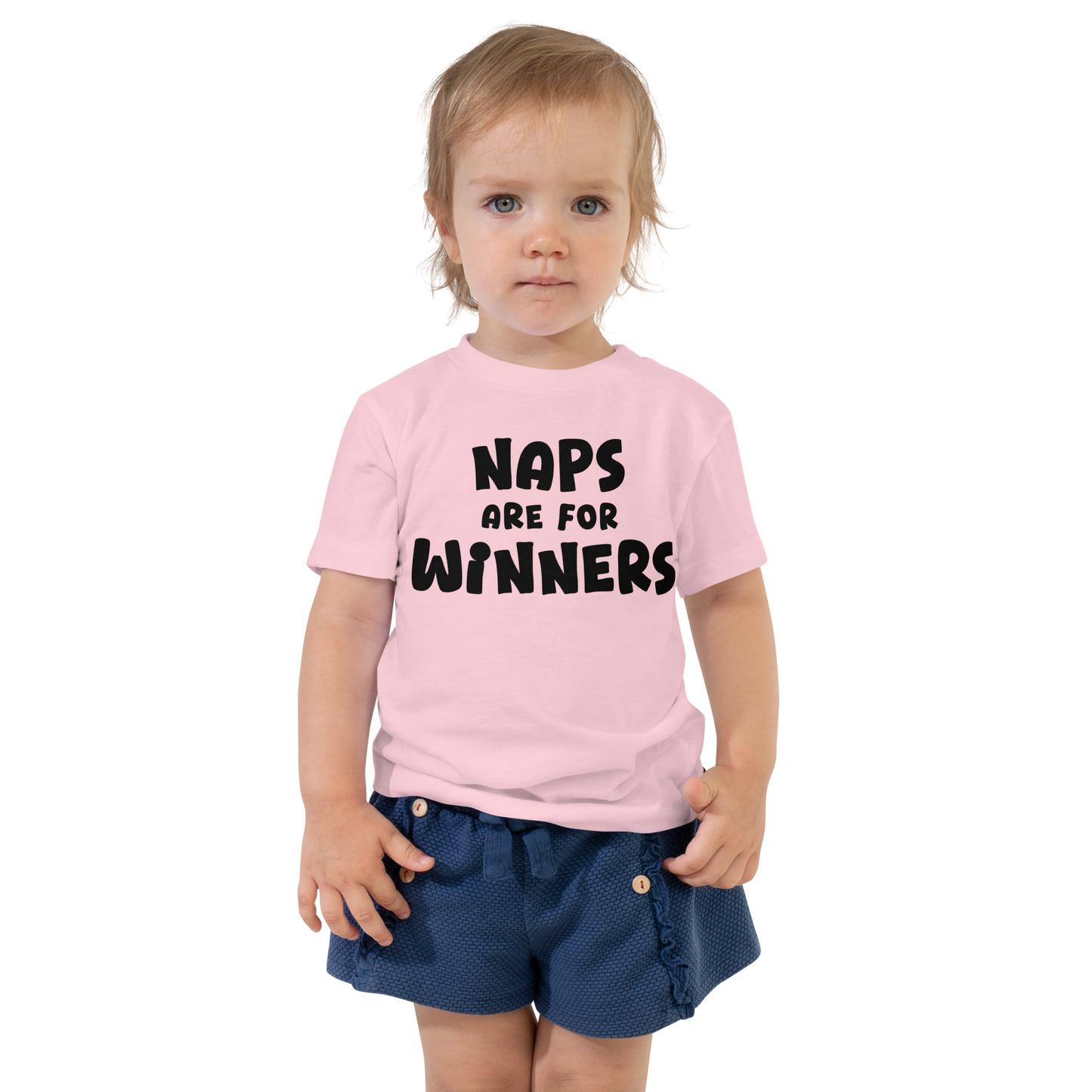 "Naps Are For Winners" printed on a pink toddler short sleeve tee worn by a female