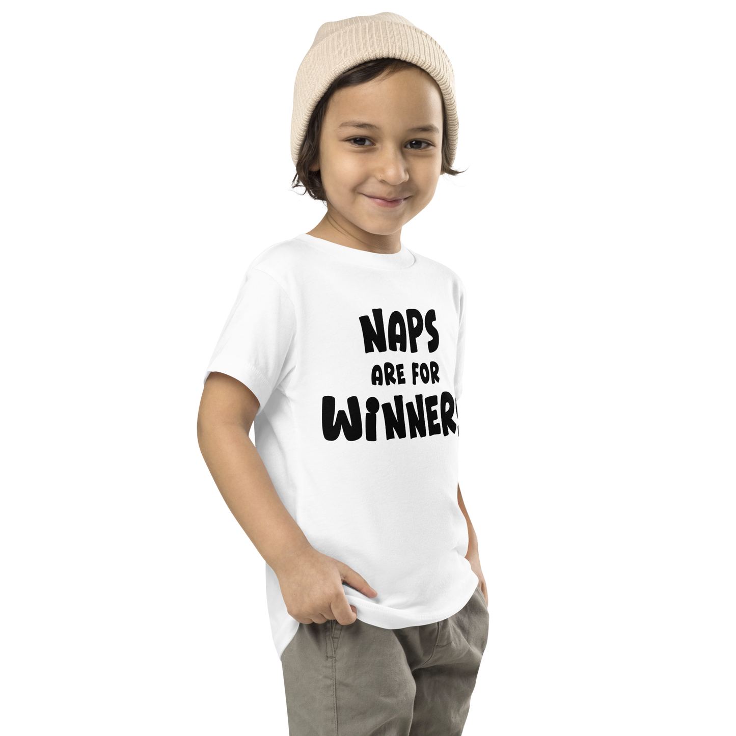 "Naps Are For Winners" printed on a white toddler short sleeve tee worn by a male who is also wearing a knit cap