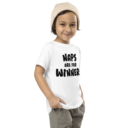 "Naps Are For Winners" printed on a white toddler short sleeve tee worn by a male who is also wearing a knit cap