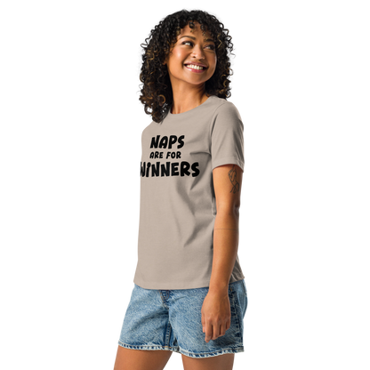 "Naps Are For Winners" printed on a heather stone women's relaxed t-shirt worn by a female