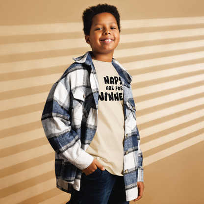 "Naps Are For Winners" printed on a natural youth classic tee worn by a male also wearing a jacket