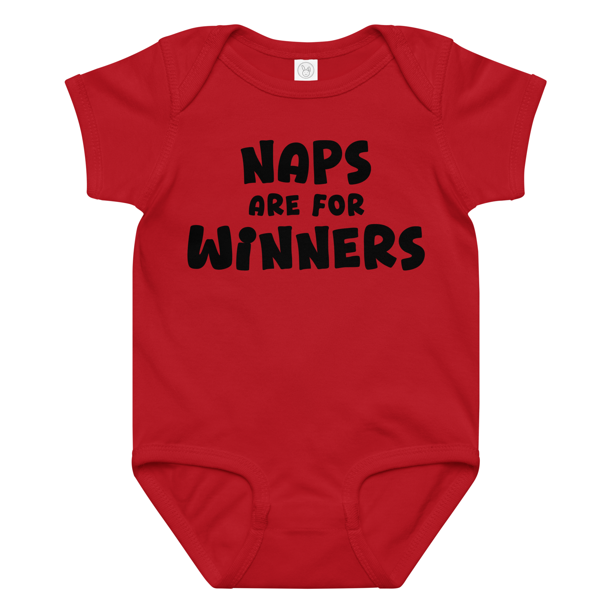 "Naps Are For Winners" printed on a red baby jersey bodysuit laying on a flat surface amongst other clothes