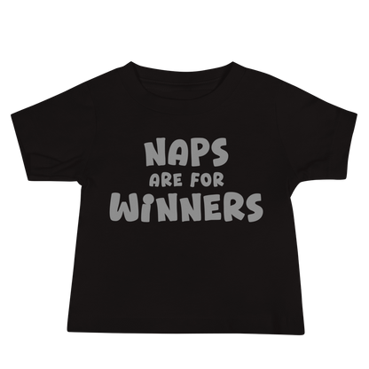 "Naps Are For Winners" printed on a black baby jersey short sleeve tee laying on a flat surface