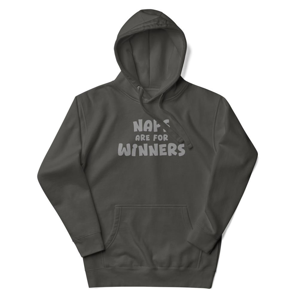 "Naps Are For Winners" printed on a vintage black unisex hoodie laying on a flat surface with the hood up