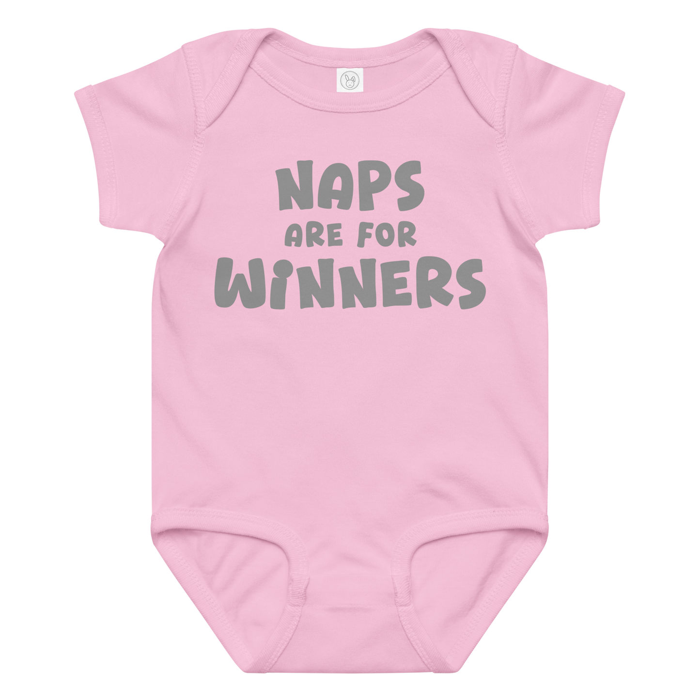 "Naps Are For Winners" printed on a pink baby jersey bodysuit laying on a flat surface amongst other clothes