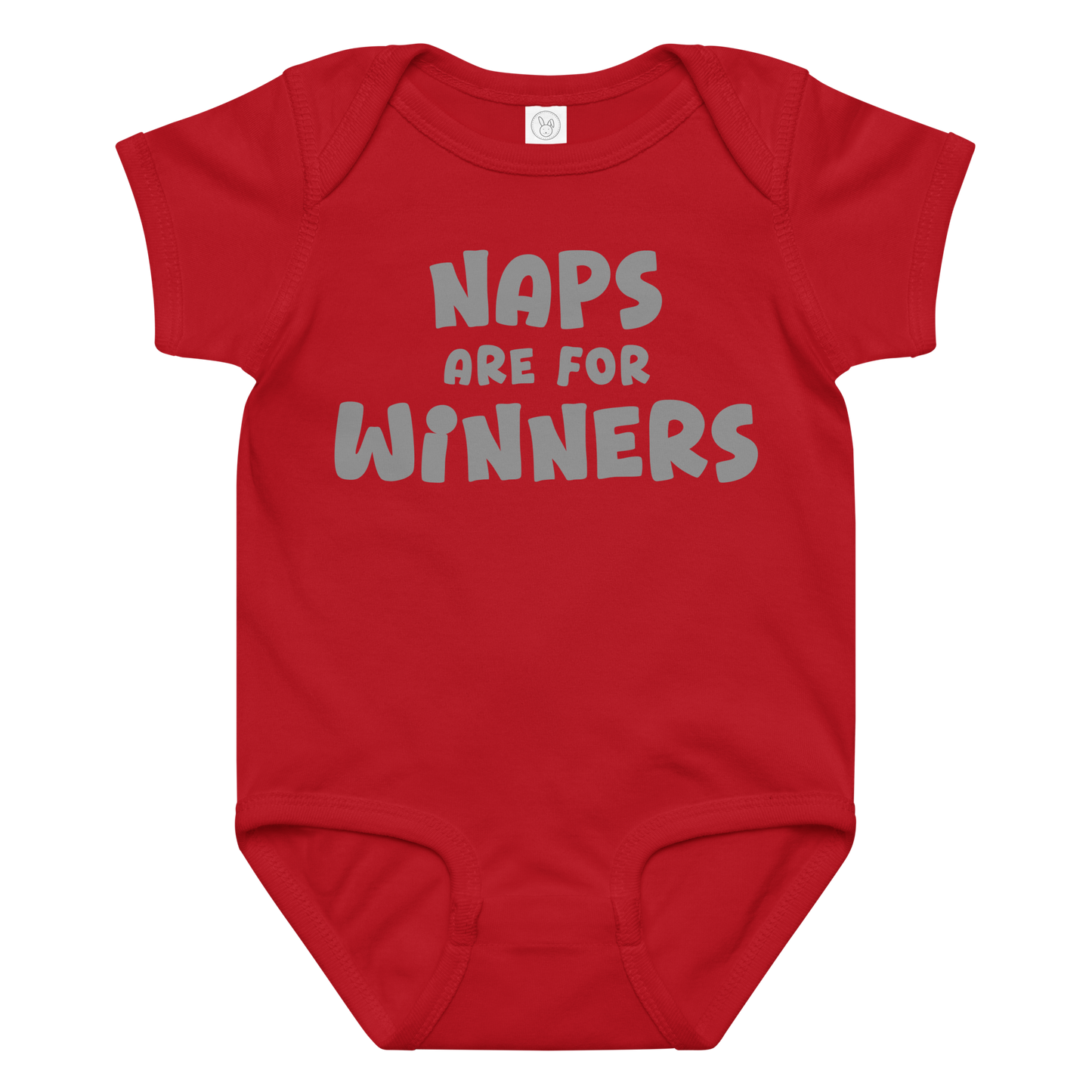 "Naps Are For Winners" printed on a red baby jersey bodysuit laying on a flat surface amongst other clothes