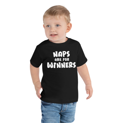 "Naps Are For Winners" printed on a black toddler short sleeve tee worn by a male