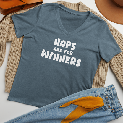 "Naps Are For Winners" printed on a heather slate women's relaxed v-neck t-shirt laying on a flat surface amongst other clothes
