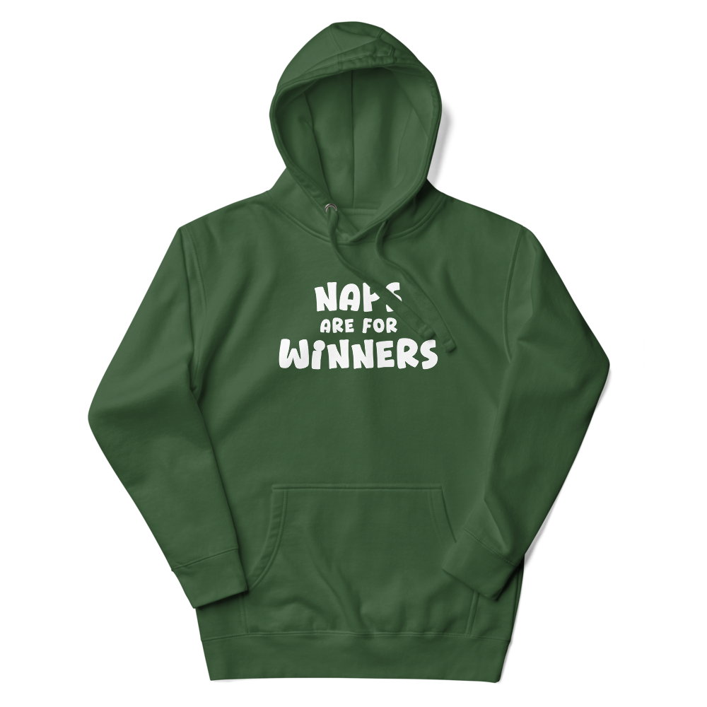 "Naps Are For Winners" printed on a forest green unisex hoodie laying on a flat surface with the hood up